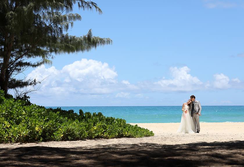 landscape image of wedding couple on beach