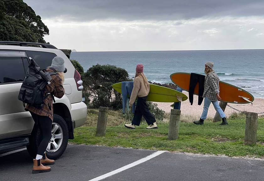 Image of women holding surfboards