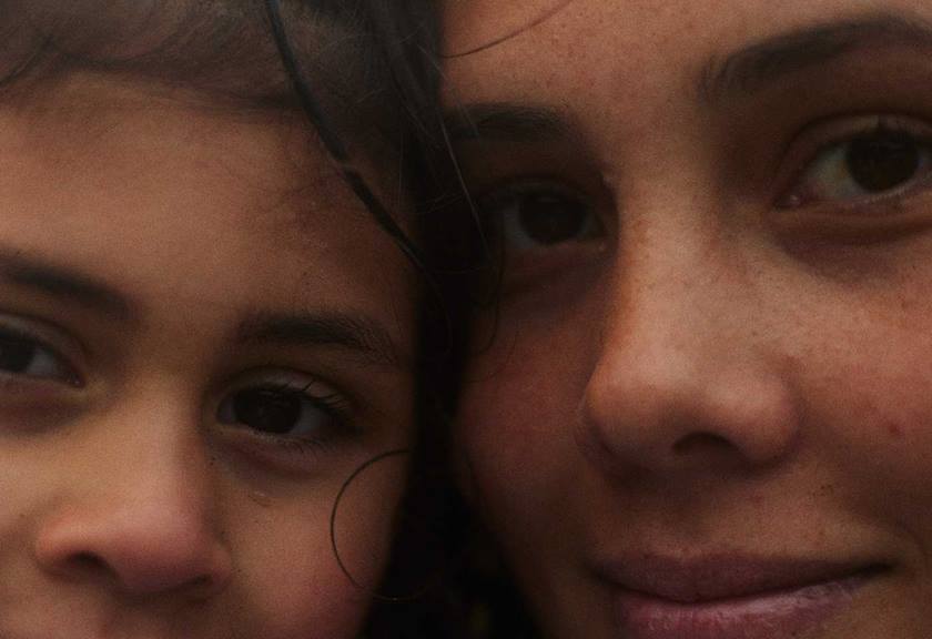 Up close image of a mother and daughter's faces