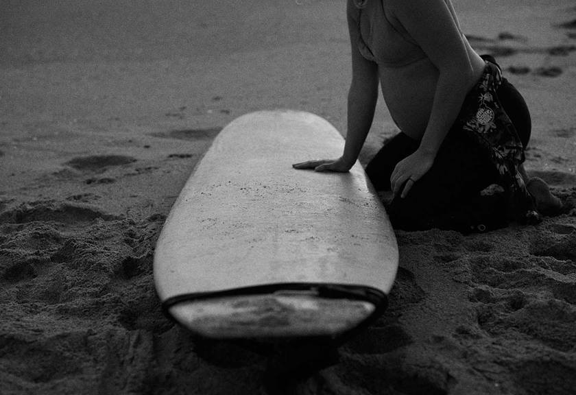 Image of a woman and her surfboard