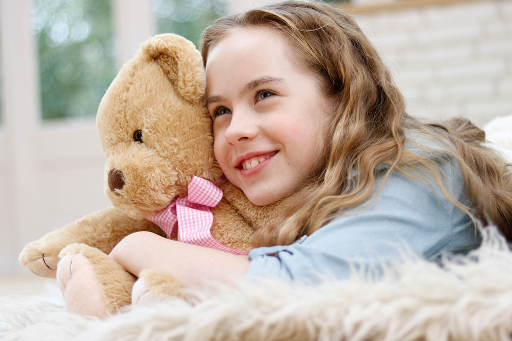 Child with teddy bear taken using EF 50mm f/1.8 STM