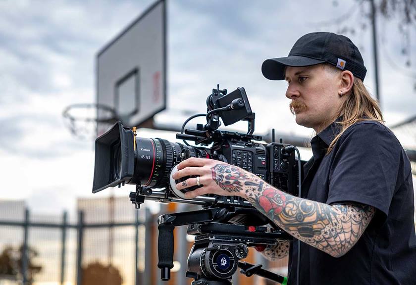 Tattooed camera man filming using Canon cinema gear