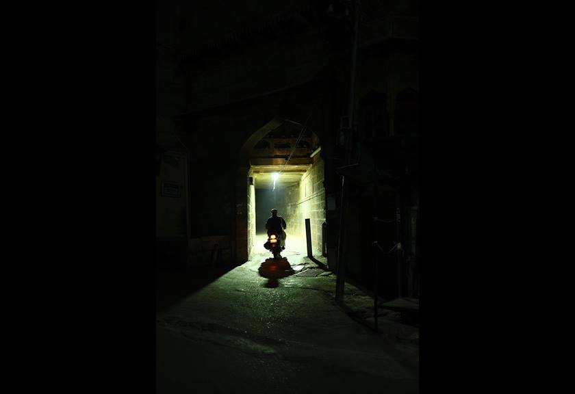 Image of a motorcyclist in a dark alley