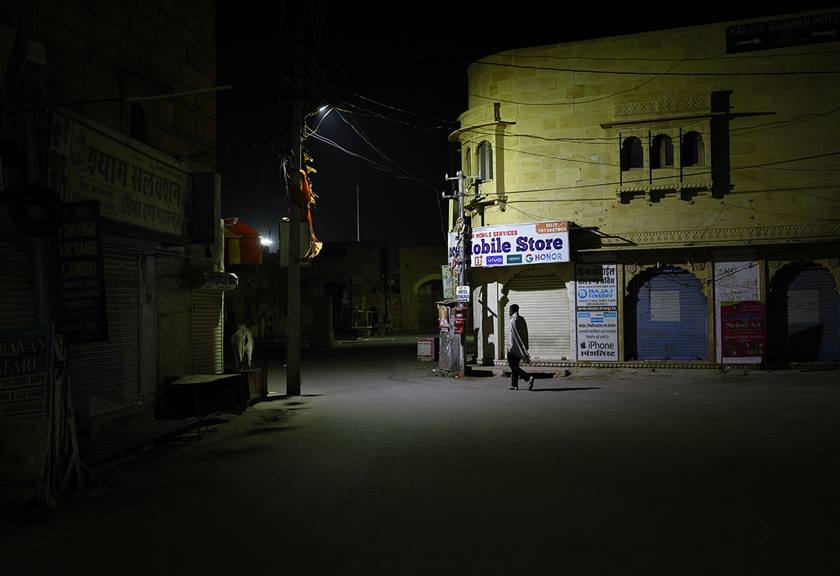 Image of a dark street with only a lamp post as a source of light