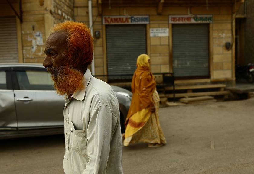 Image of a man and woman walking opposite ways on a street