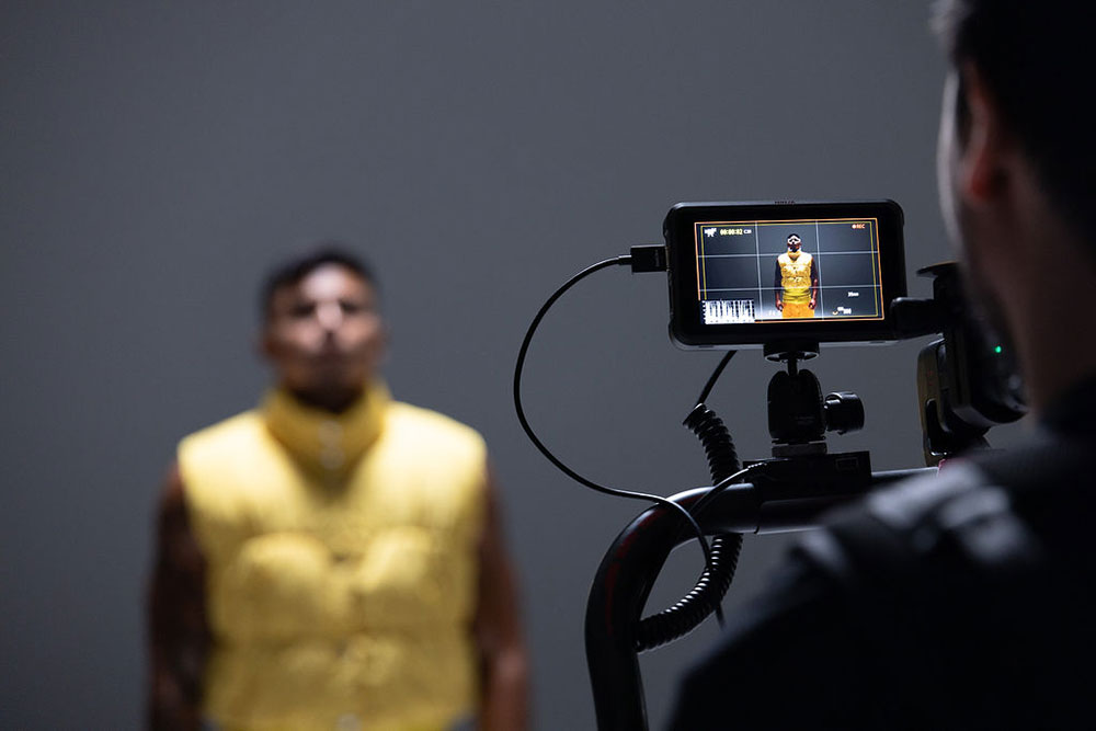 Steven Chee photographing a model in yellow vest using the EOS R5 Mark II camera