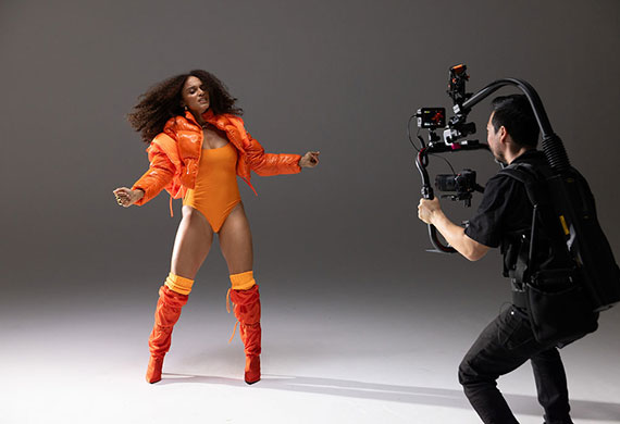 Steven Chee filming a dancer dancing in orange outfit using the EOS R5 Mark II camera