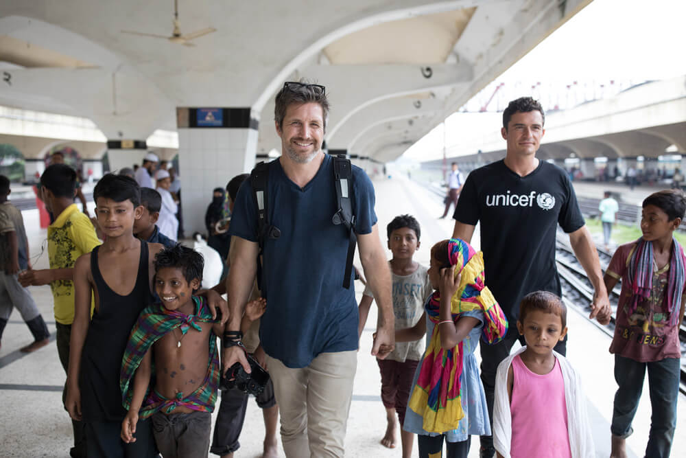 Orlando Bloom and Simon Lister with children in Bangladesh